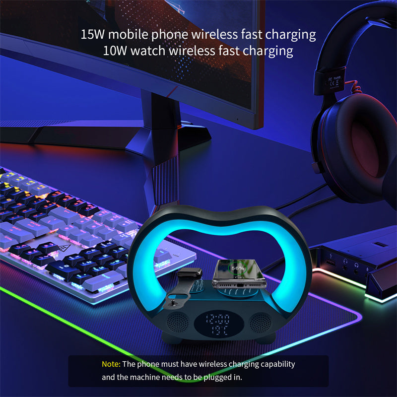 Gaming setup with a wireless charging pad, monitor, keyboard, and headphones on a desk.