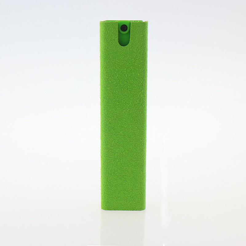 Green rectangular object with a black button on a white background