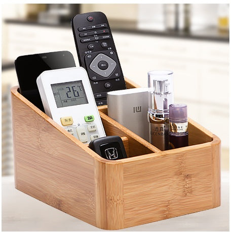 Wooden organizer with electronic devices and bottles on a blurred background