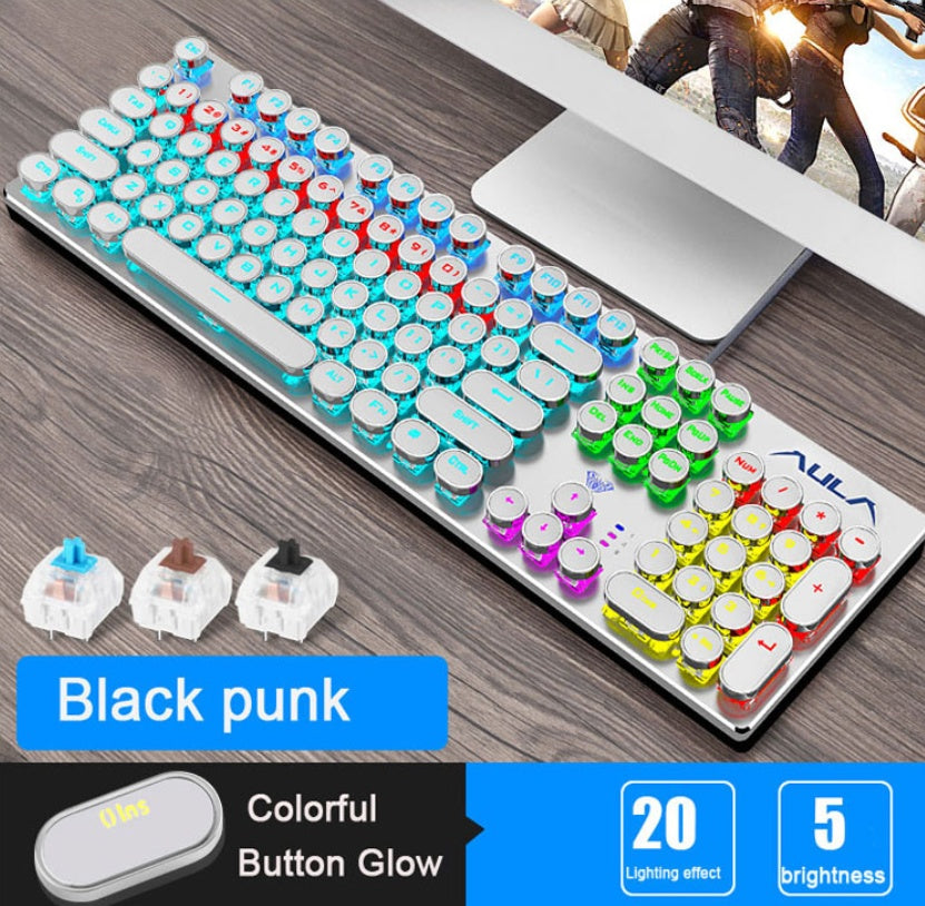 Colorful keyboard with customizable keycaps on a desk next to a computer monitor.