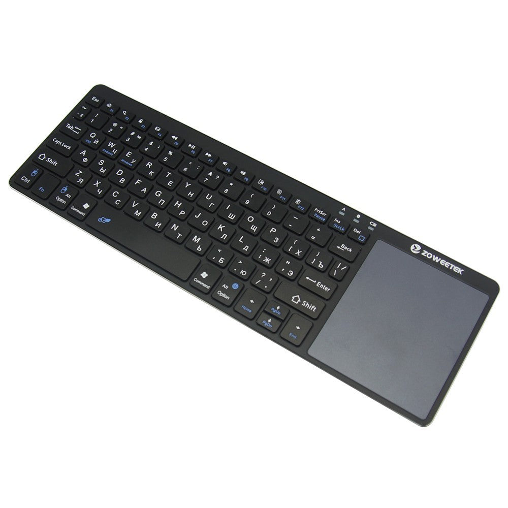 Black keyboard with touchpad on a white background