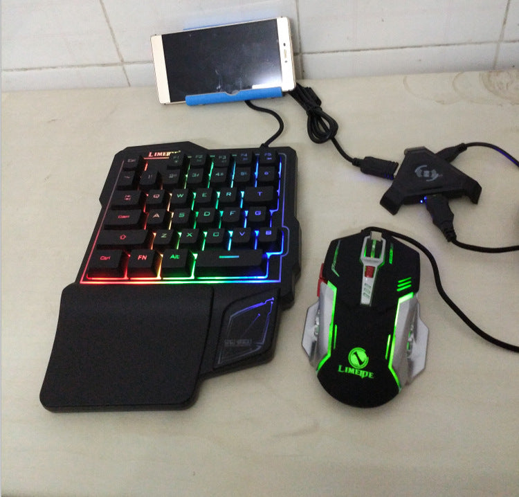 Gaming keyboard and mouse set with smartphone on a tiled surface