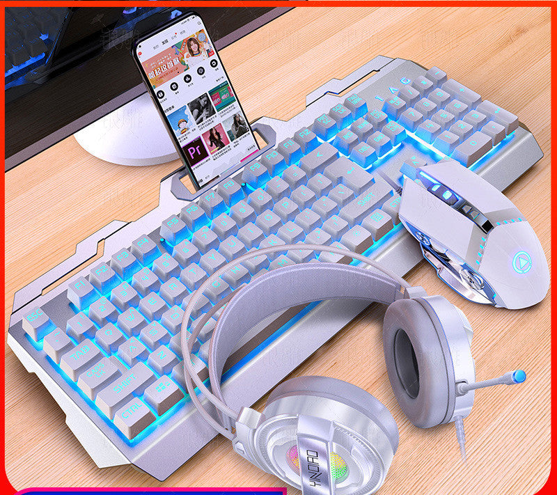 Gaming keyboard, mouse, and headphones on a desk with a smartphone displaying a video.
