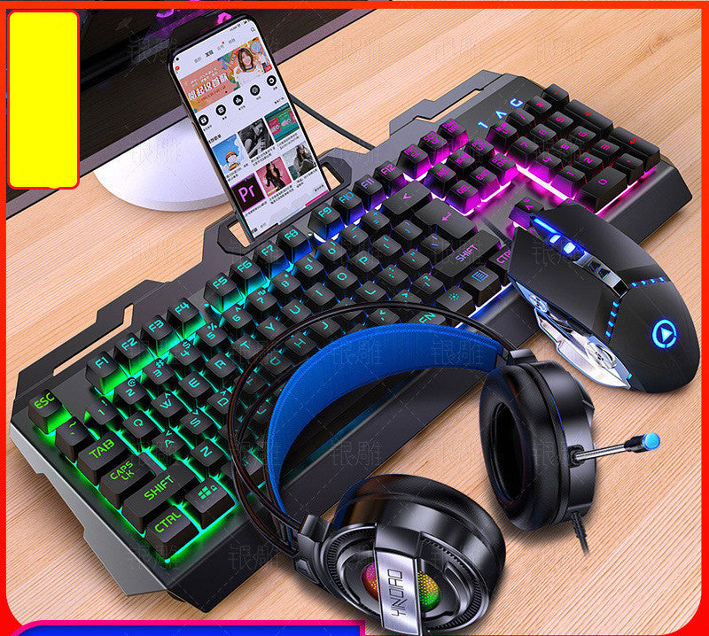 Gaming keyboard, mouse, and headphones on a wooden surface with a smartphone displaying a music app.