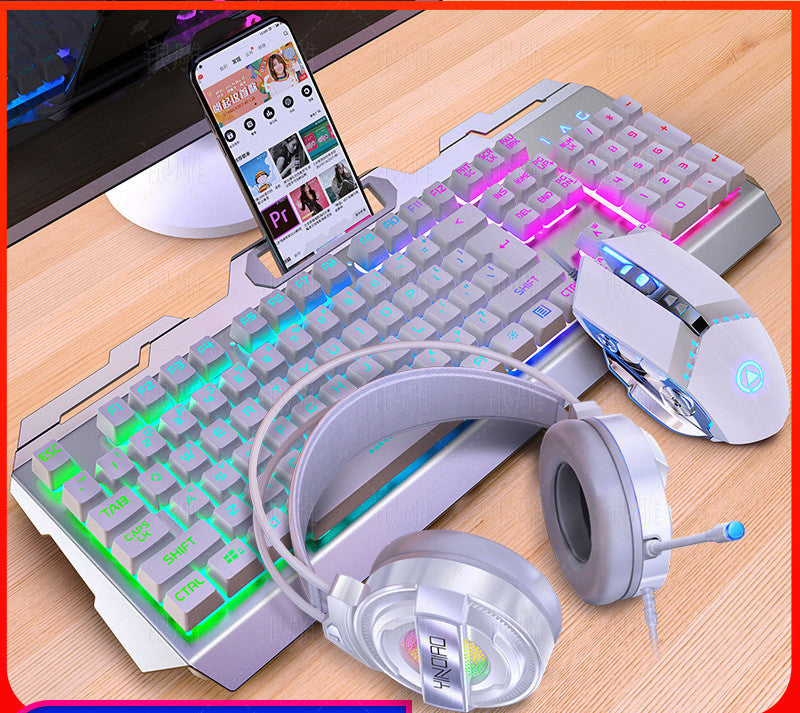 Gaming keyboard, mouse, and headphones on a desk with a smartphone displaying a music app.