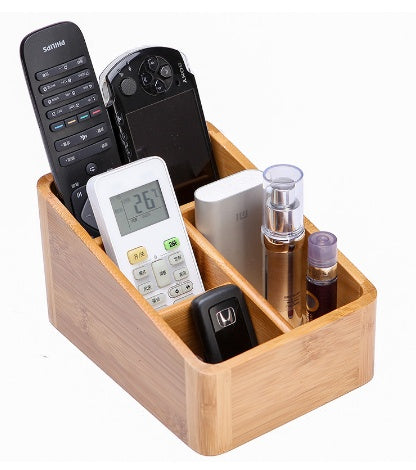 Wooden organizer holding various remote controls and electronic devices on a white background