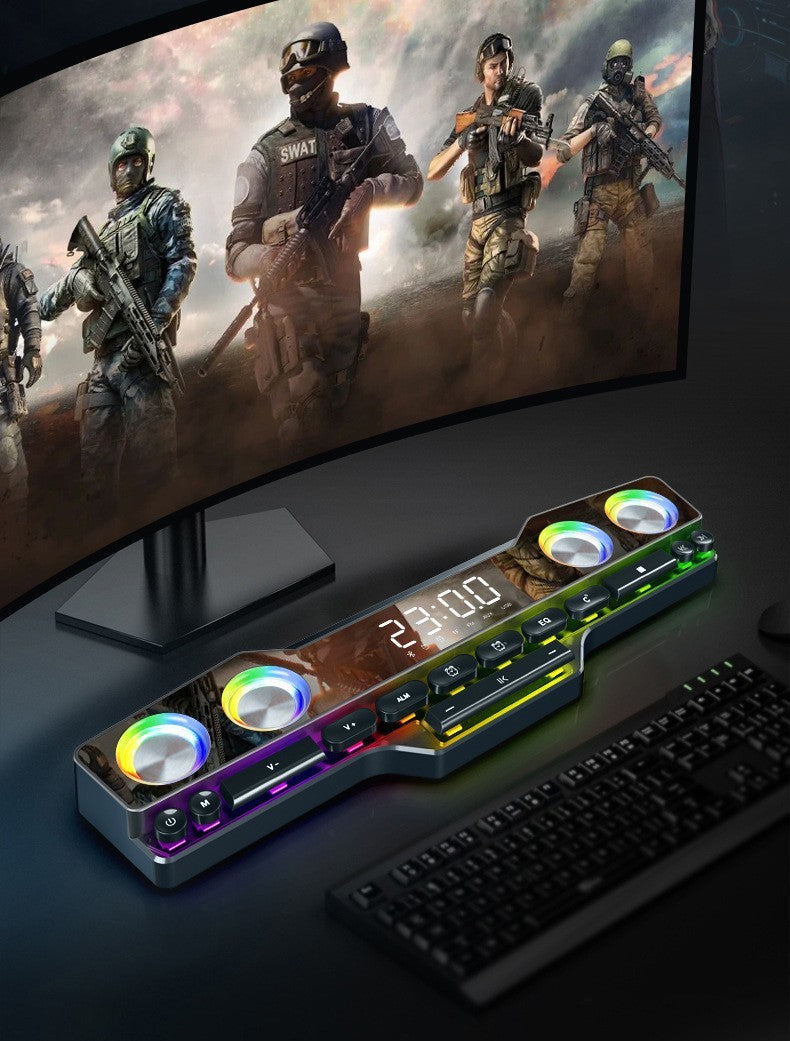 Gaming setup with a monitor displaying soldiers, a RGB desk lamp, and keyboard.