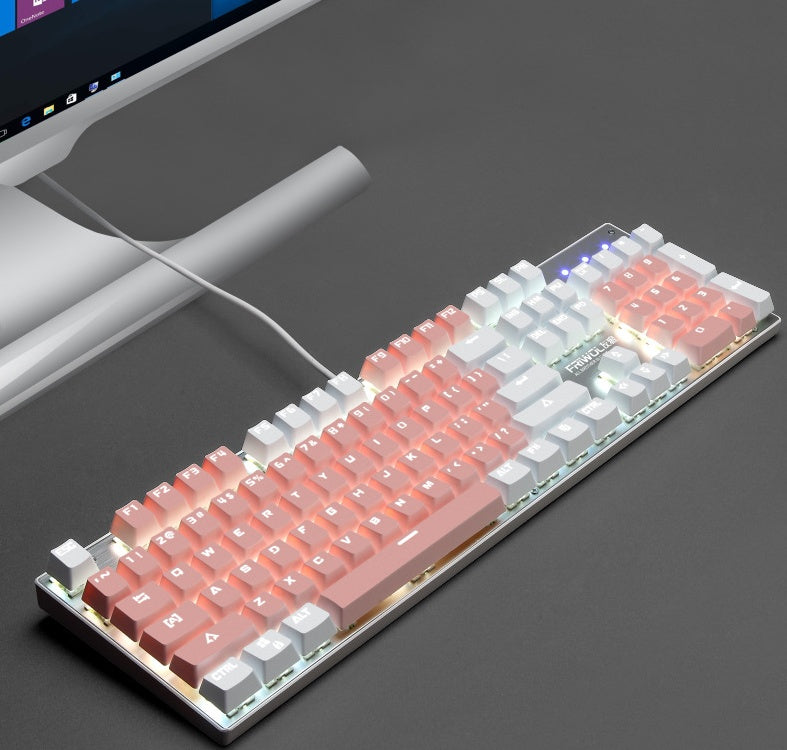 Mechanical keyboard with RGB lighting on a dark surface next to a computer monitor.