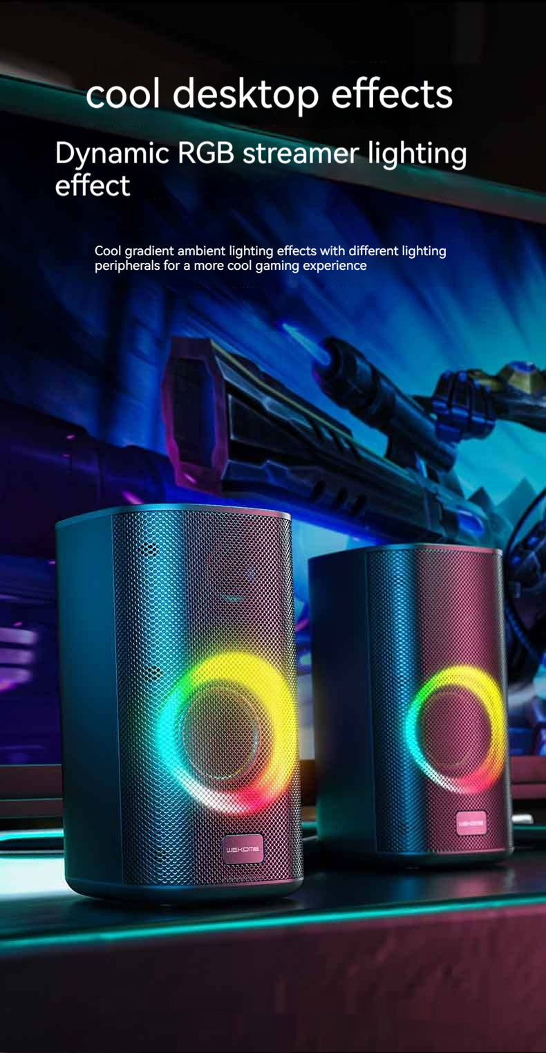 Gaming setup with RGB speakers and dynamic lighting effects on a dark background