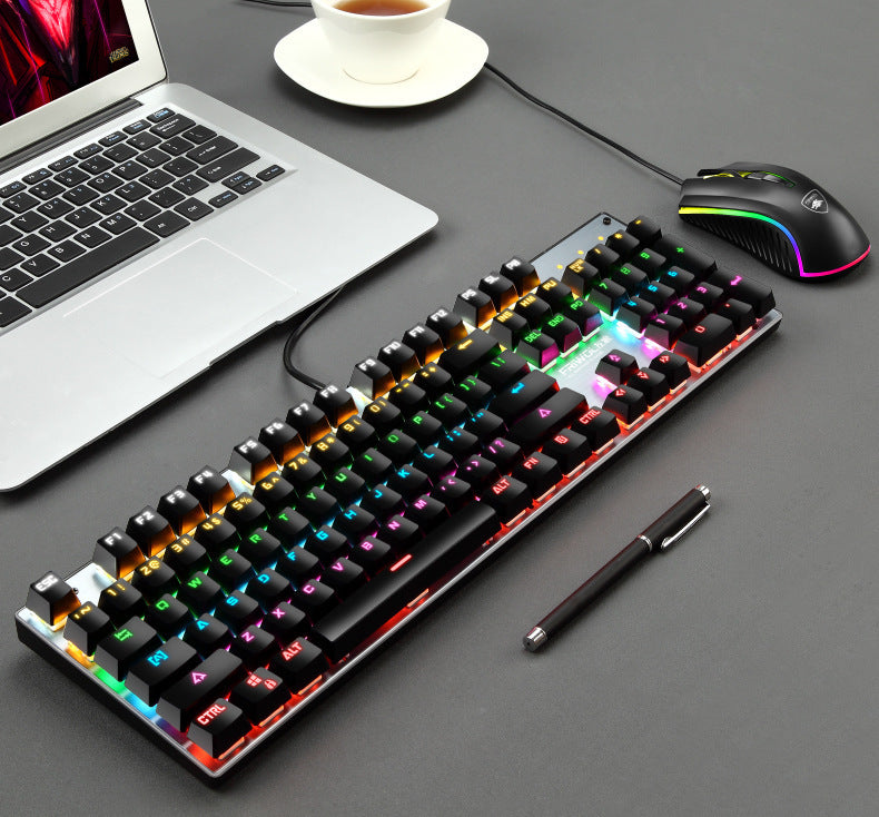 Gaming keyboard, mouse, and laptop on a desk with a pen.