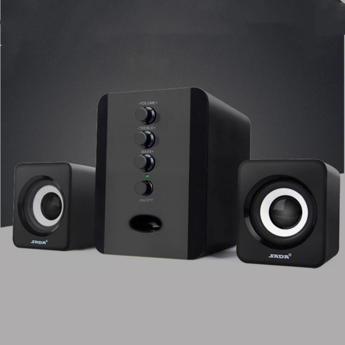 Black computer speakers with control panel on a gray background