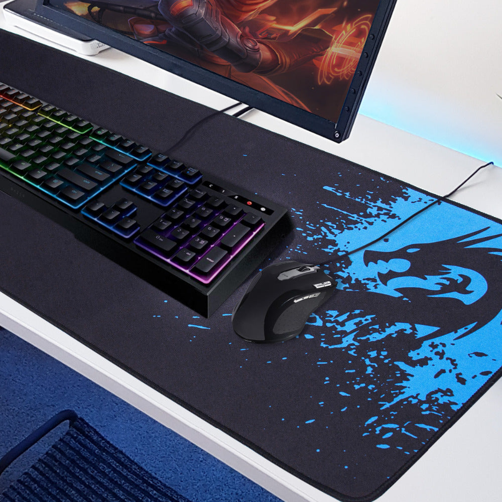 Gaming setup with keyboard, mouse, and large mouse pad on a desk.