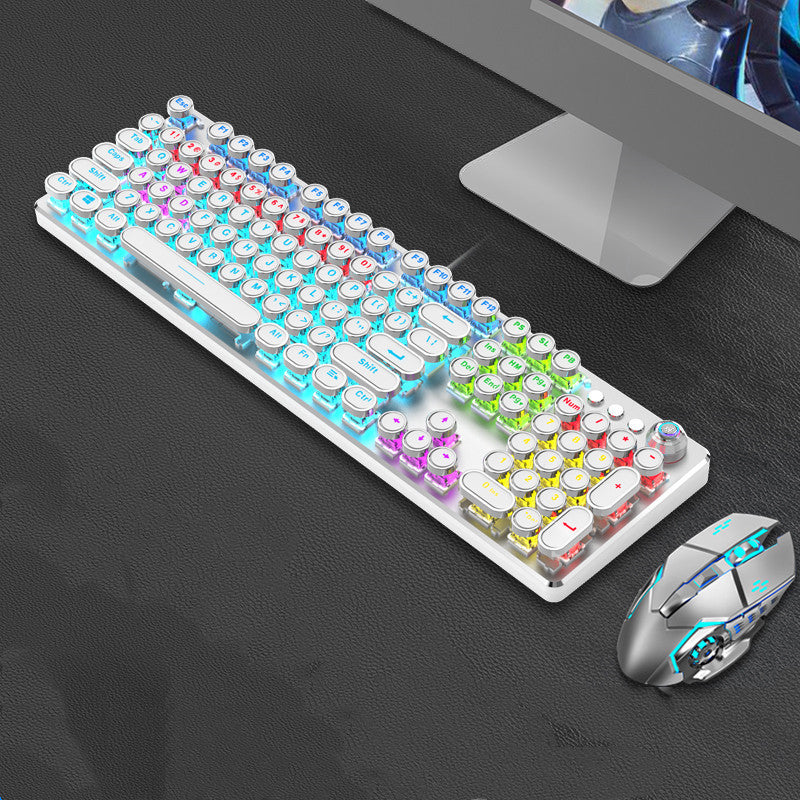 Colorful keyboard and mouse set on a dark surface with a computer monitor in the background.