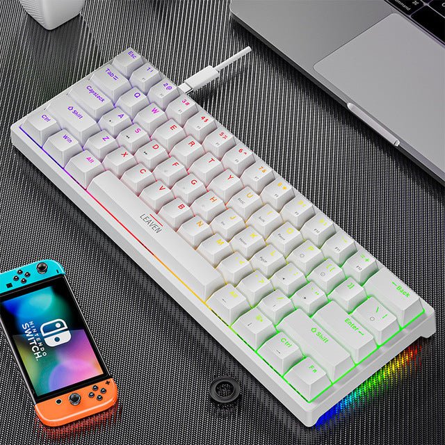 Mechanical keyboard with RGB lighting on a desk next to a smartphone and laptop.