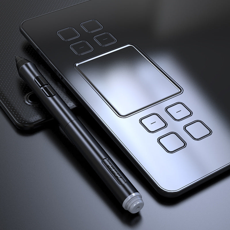 Graphic tablet with stylus on a dark surface