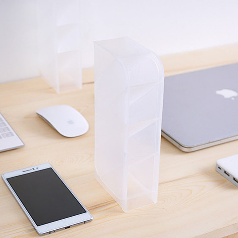 Clear plastic bag on a wooden desk with a smartphone, mouse, and laptop.