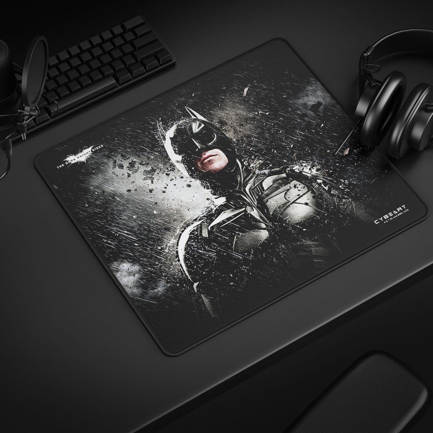 Mouse pad with superhero design on a desk with keyboard and headphones