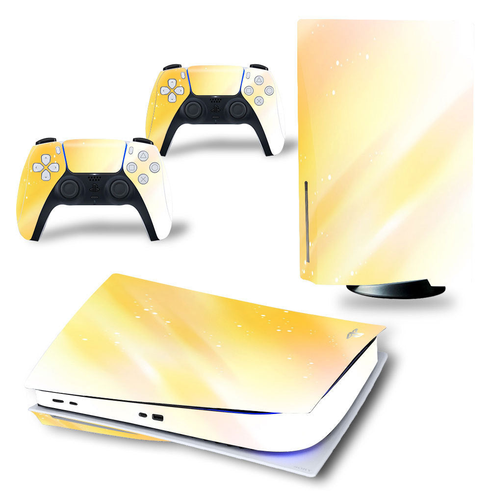 Gaming console and controllers with yellow gradient skin design on a white background