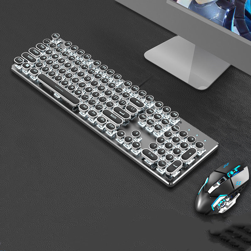 Gaming keyboard and mouse set on a dark surface with a computer monitor in the background.