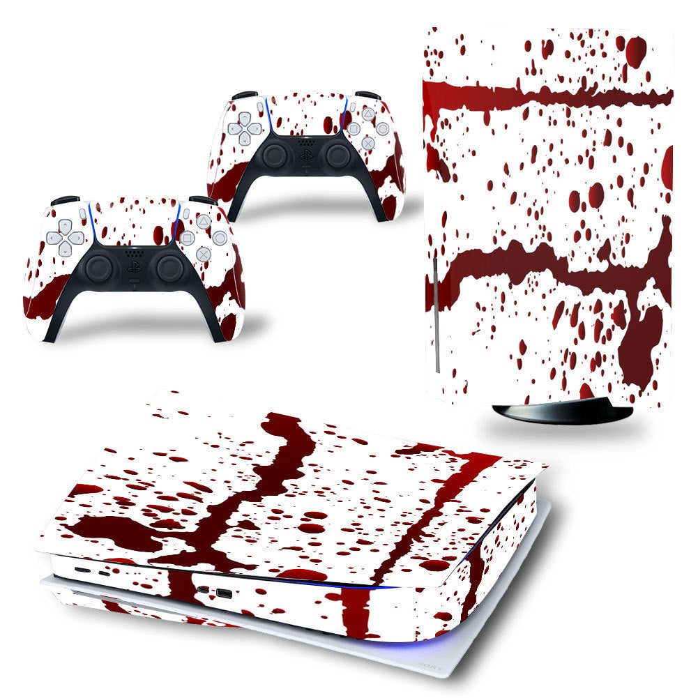 Gaming console and controllers with a blood splatter design on a white background