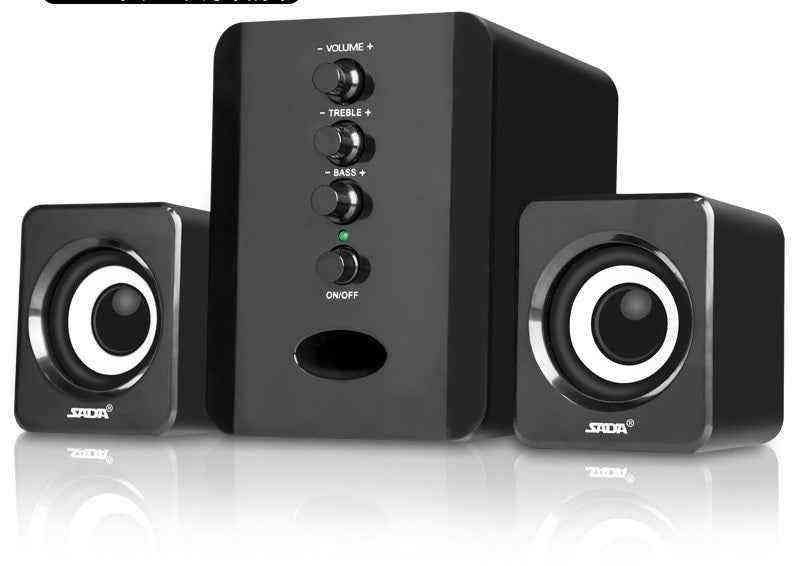 Black computer speakers with control buttons on a white background