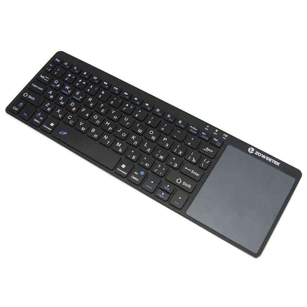 Black keyboard with touchpad on a white background