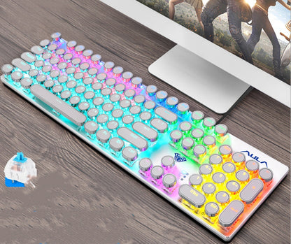 Colorful keyboard on a desk with a computer monitor in the background