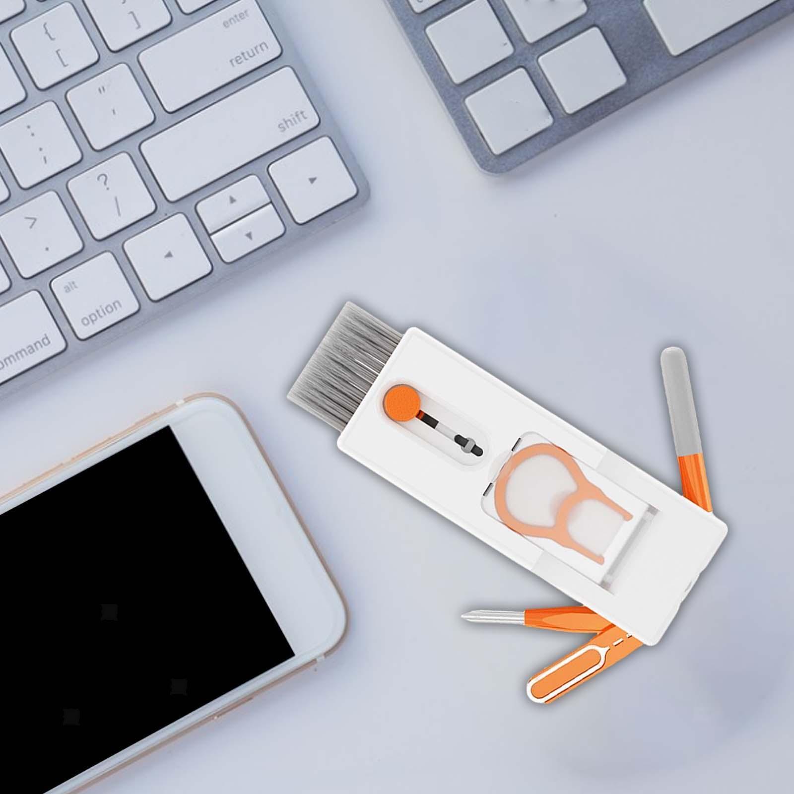 Cleaning tools on a desk with a smartphone and keyboard in the background