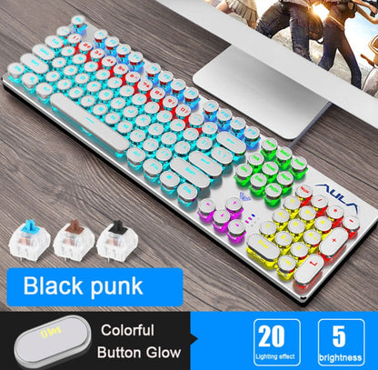 Colorful keyboard with customizable keycaps on a desk next to a computer monitor.