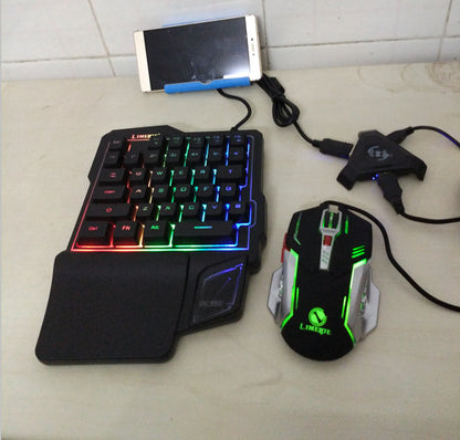 Gaming keyboard and mouse set with smartphone on a tiled surface