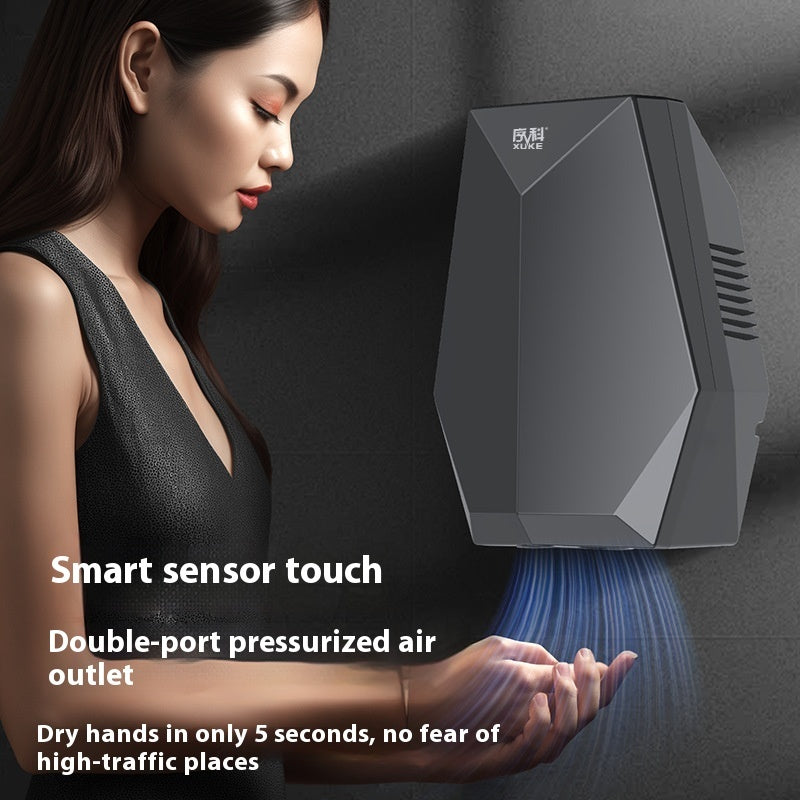 Woman using a smart hand dryer with text highlighting features