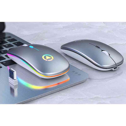 Two wireless computer mice on a laptop with a USB cable, on a light gray surface.