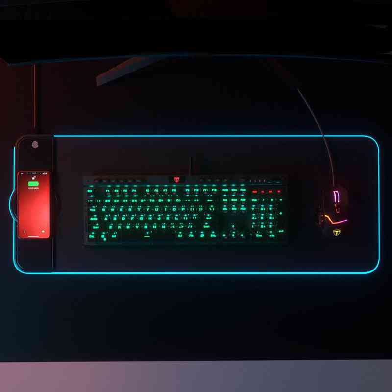 Gaming keyboard and mouse setup with illuminated keys on a dark background