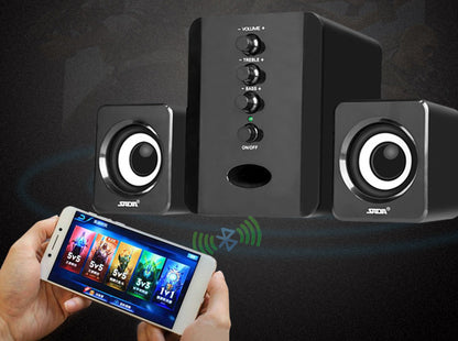 Black speaker system with control knobs and a smartphone displaying music app on a dark background
