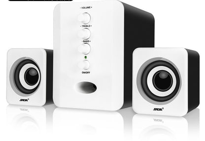 White computer speakers with control buttons on a white background