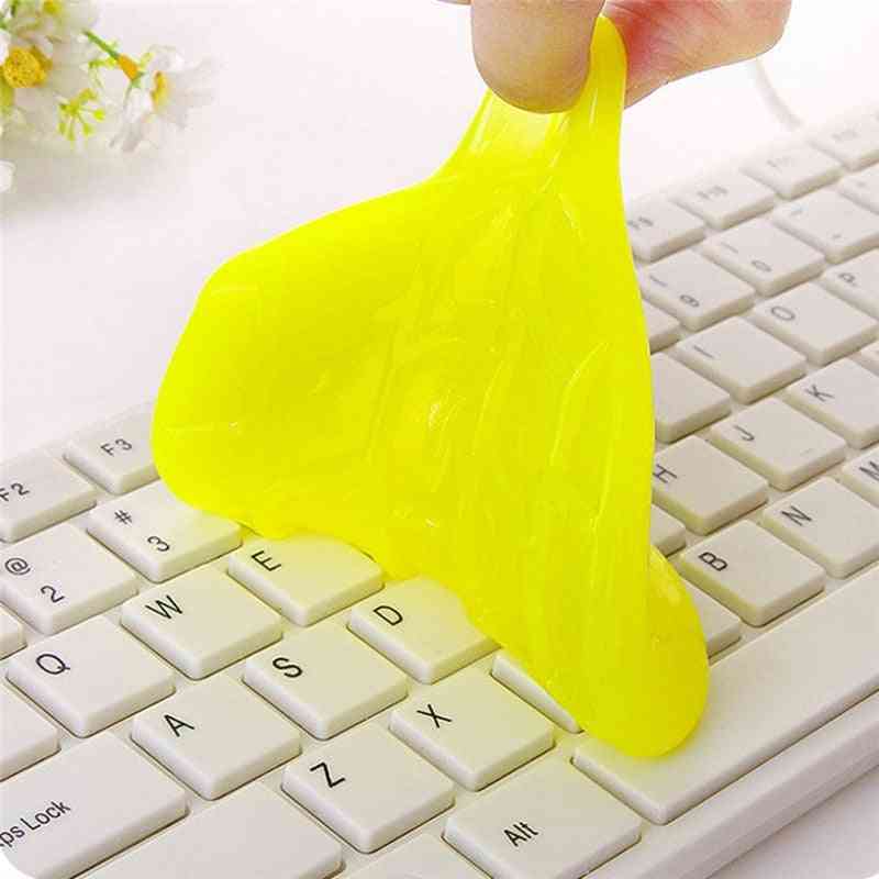 Universal Keyboard Cleaning Glue Yellow slime being stretched over a keyboard