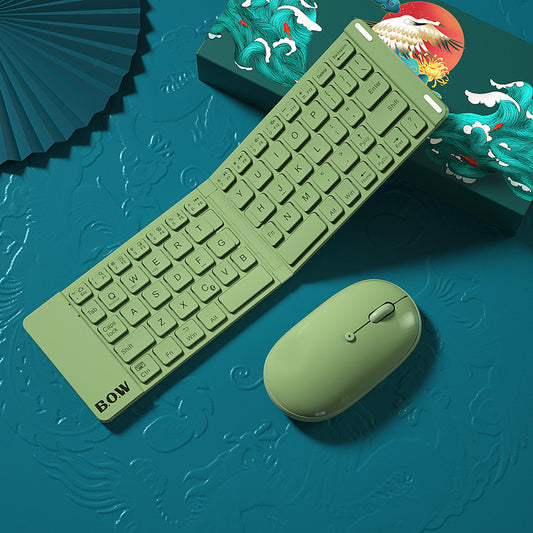 Green keyboard and mouse set on a blue textured background with decorative elements.