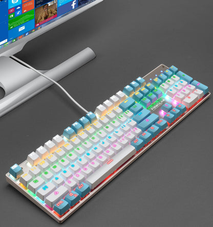 Colorful mechanical keyboard on a dark surface with a computer monitor in the background