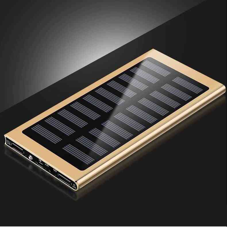 Gold solar power bank with black solar panel on a dark background