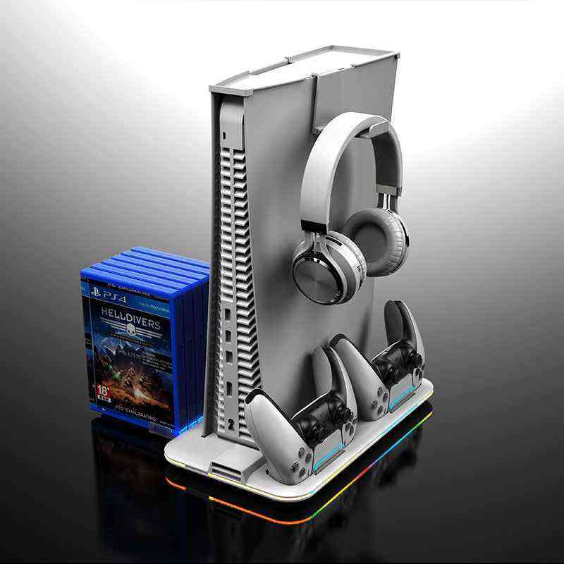 Gaming console with headset and controllers on a stand, next to a game case on a reflective surface.