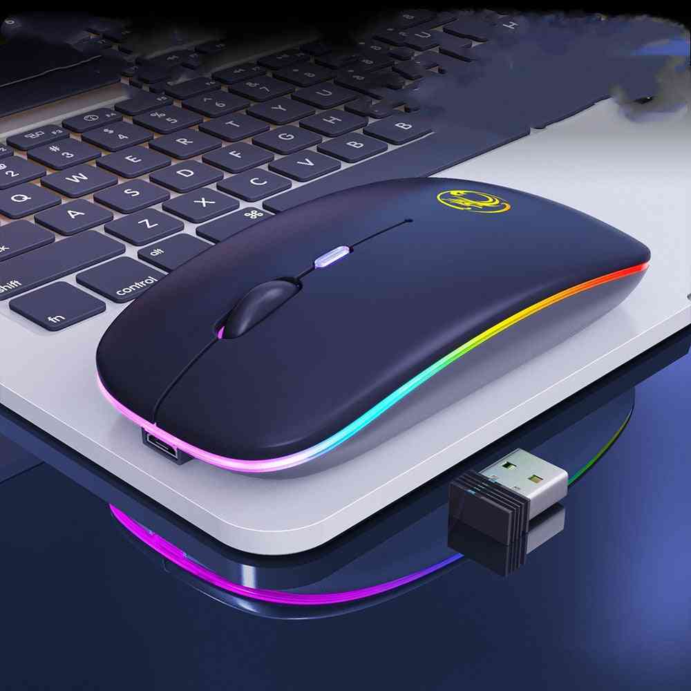 Blue wireless mouse with RGB lighting on a laptop keyboard