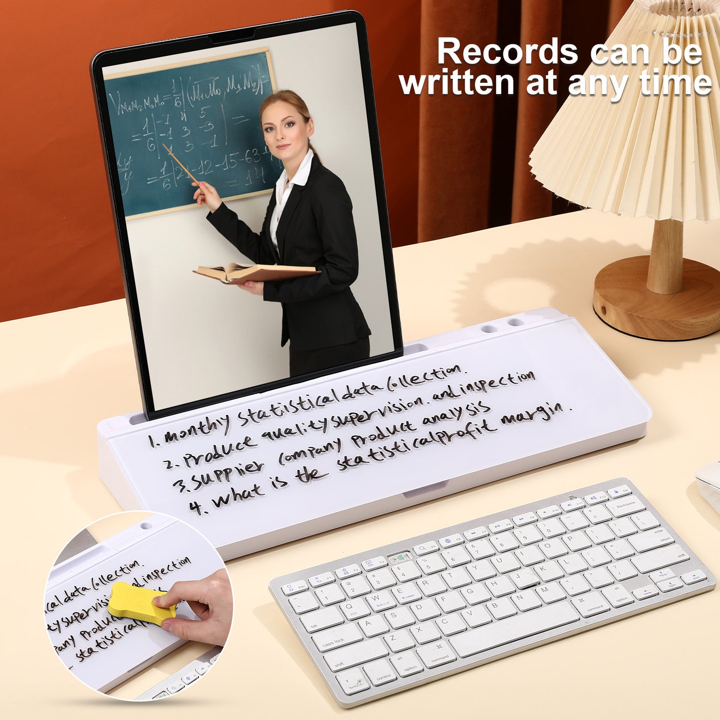Electronic writing pad with screen displaying a teacher and keyboard on a desk.