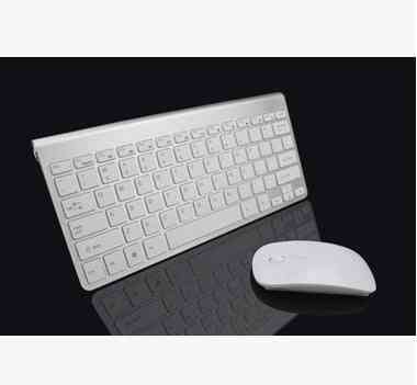 White keyboard and mouse set on a reflective black surface