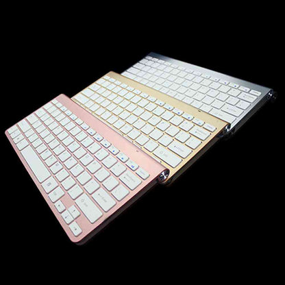 Foldable keyboard with rose gold and silver frames on a black background