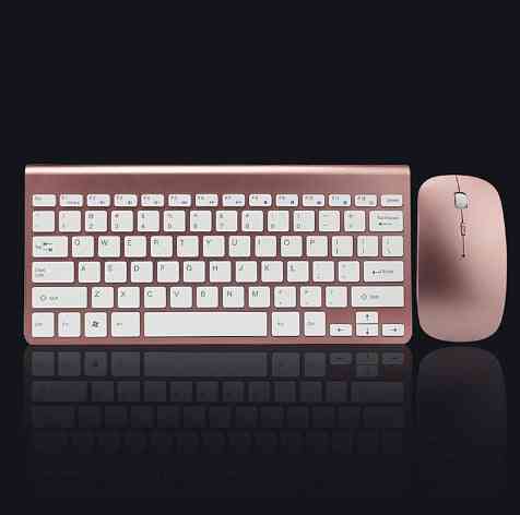Rose gold keyboard and mouse set on a black background