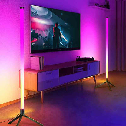 Living room with a TV on a stand, surrounded by two tall floor lamps emitting a purple glow.
