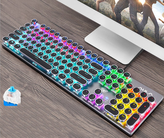 Colorful mechanical keyboard on a desk with a computer monitor in the background