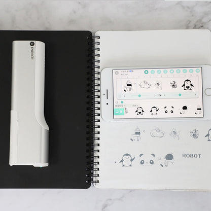 Notebook with a smartphone displaying app icons on a marble surface
