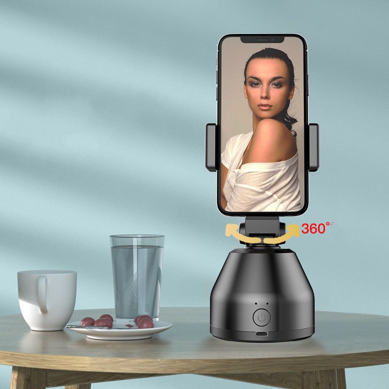Phone holder with 360-degree rotation on a table with a blurred background