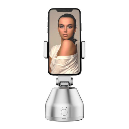 Phone holder with a smartphone displaying a woman's face on a white background